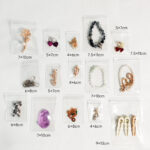 Complete size matrix for clear jewelry packaging bags, showing in-stock dimensions from 4x6cm to 9x13cm for B2B wholesale.