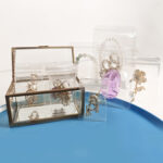 hickened transparent plastic jewelry sealing bags arranged in a glass display box, perfect for retail boutique presentation