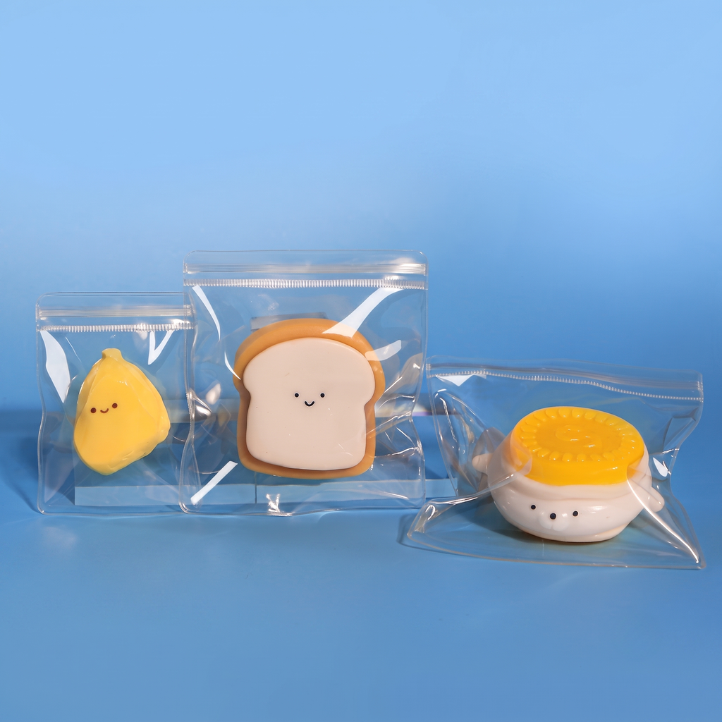 Multiple custom squishy toy packaging bags made of high-clarity PVC displaying various shapes of squishies.
