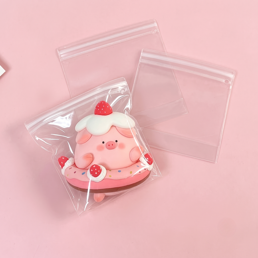 A cute pig squishy displayed inside an EVA squishy toy packaging bag, showcasing its flexible and soft material.