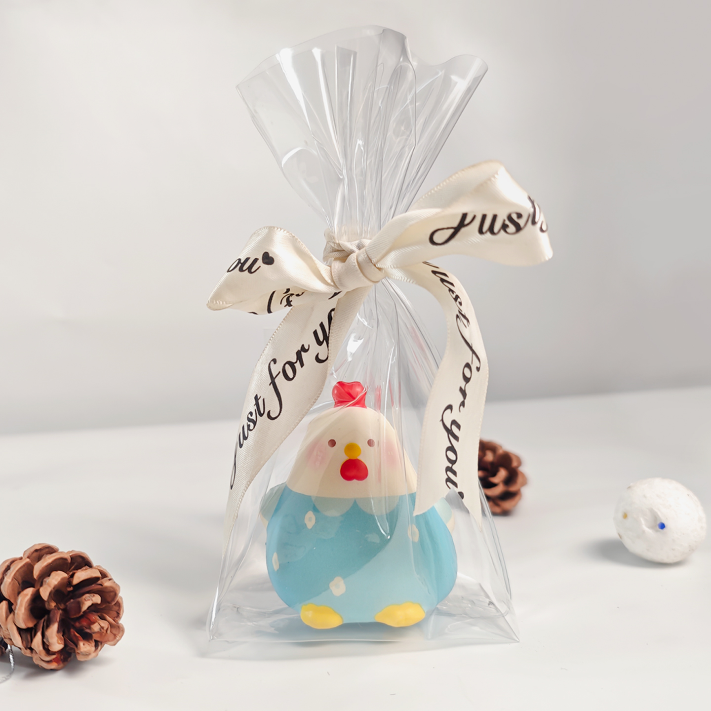 A premium squishy toy wrapped in a clear gusseted squishy toy packaging bag and tied with a printed ribbon