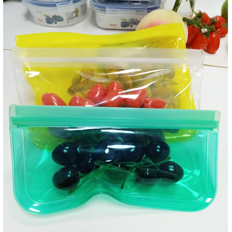 Colorful reusable EVA food storage bags containing fresh produce like cherry tomatoes and cherries, safe for kitchen use.