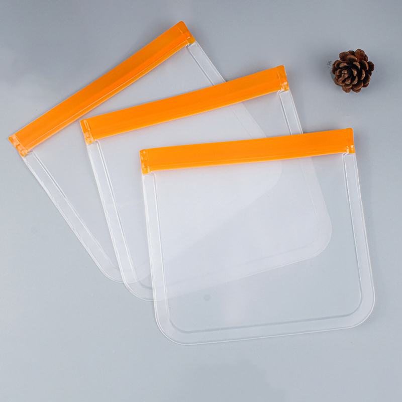 Three EVA food storage bags with durable orange zipper seals laid flat, demonstrating their thick construction for reusable purposes.
